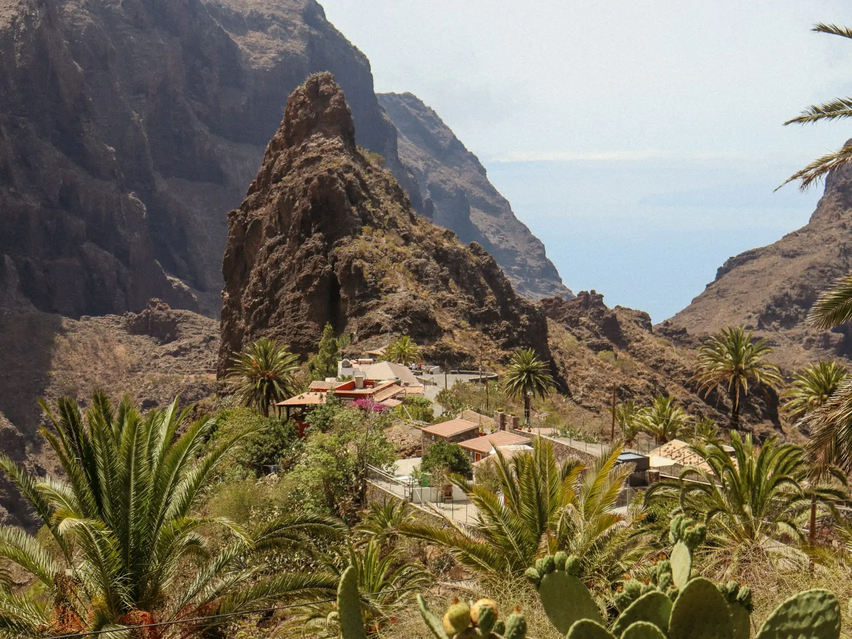 a view of a mountain with a house in the middle of it
